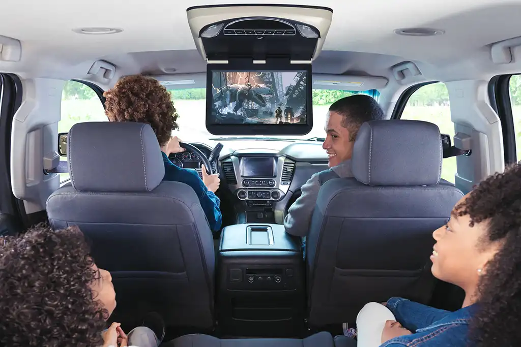 Family watching tv in SUV