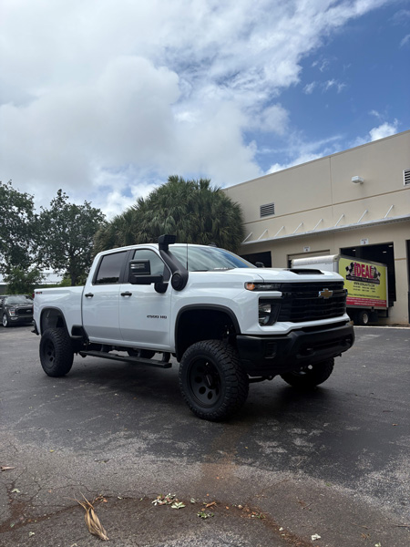 White lifted Chevrolet truck